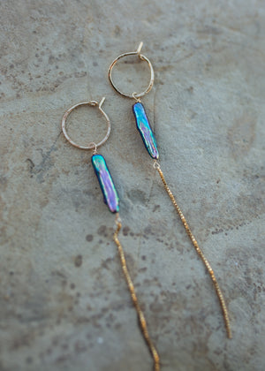 Showing the rainbow iridescence of the peacock blue pearls 