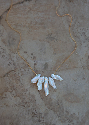 Iridescent white biwa pearls strung on a gold chain