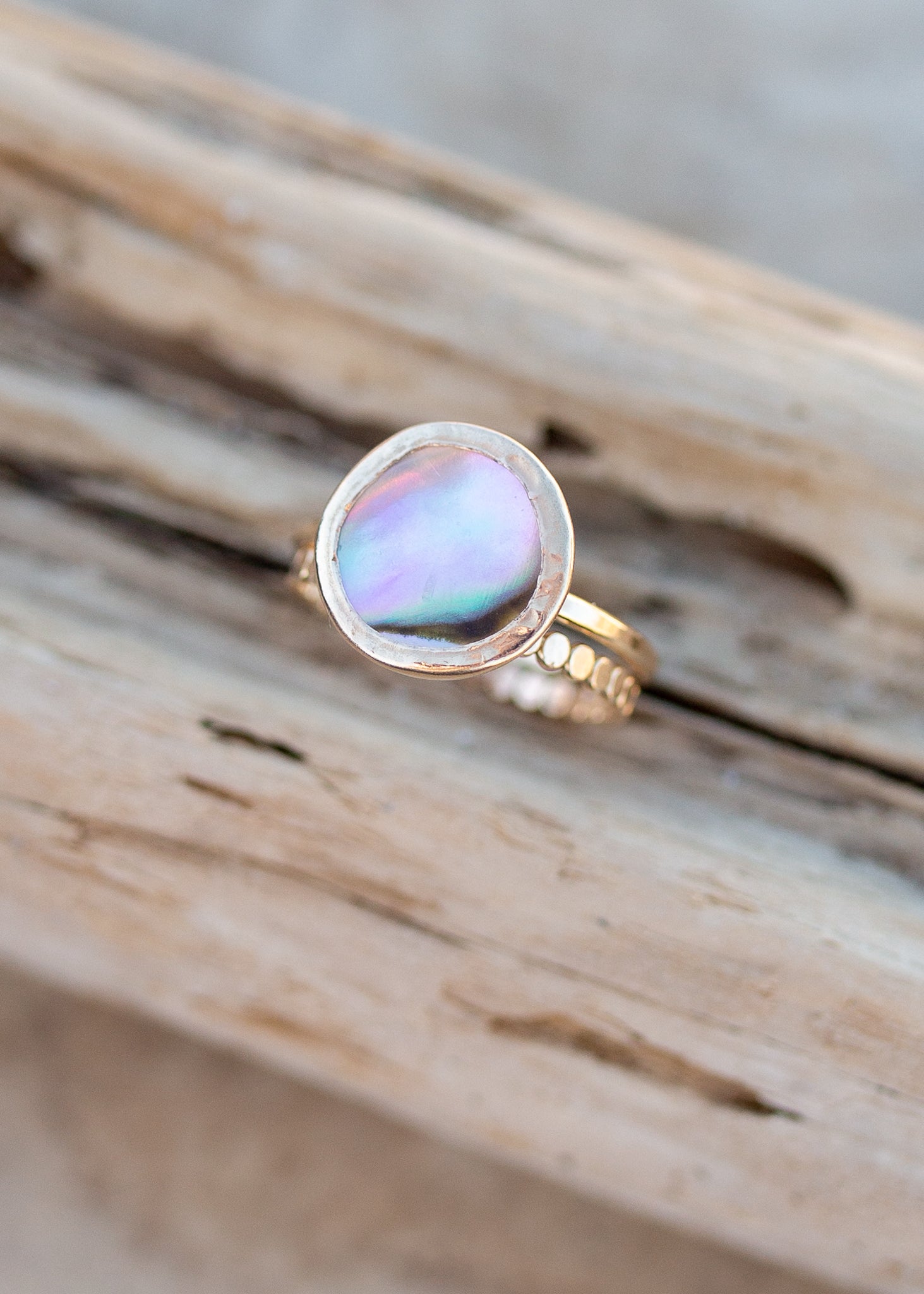 Round gold bezel ring with abalone face