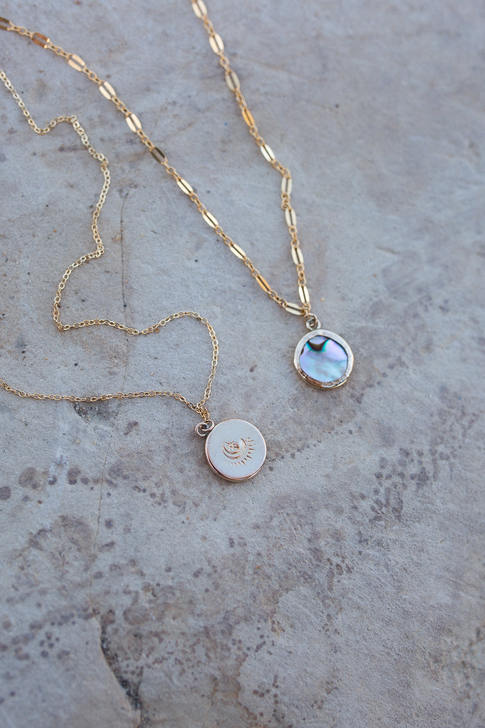 Abalone set in a round gold bezel with a dainty cable chain