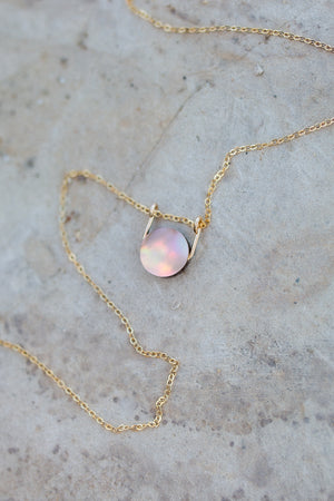 Circular mother of pearl coin with a gold sliding bail and dainty gold cable chain